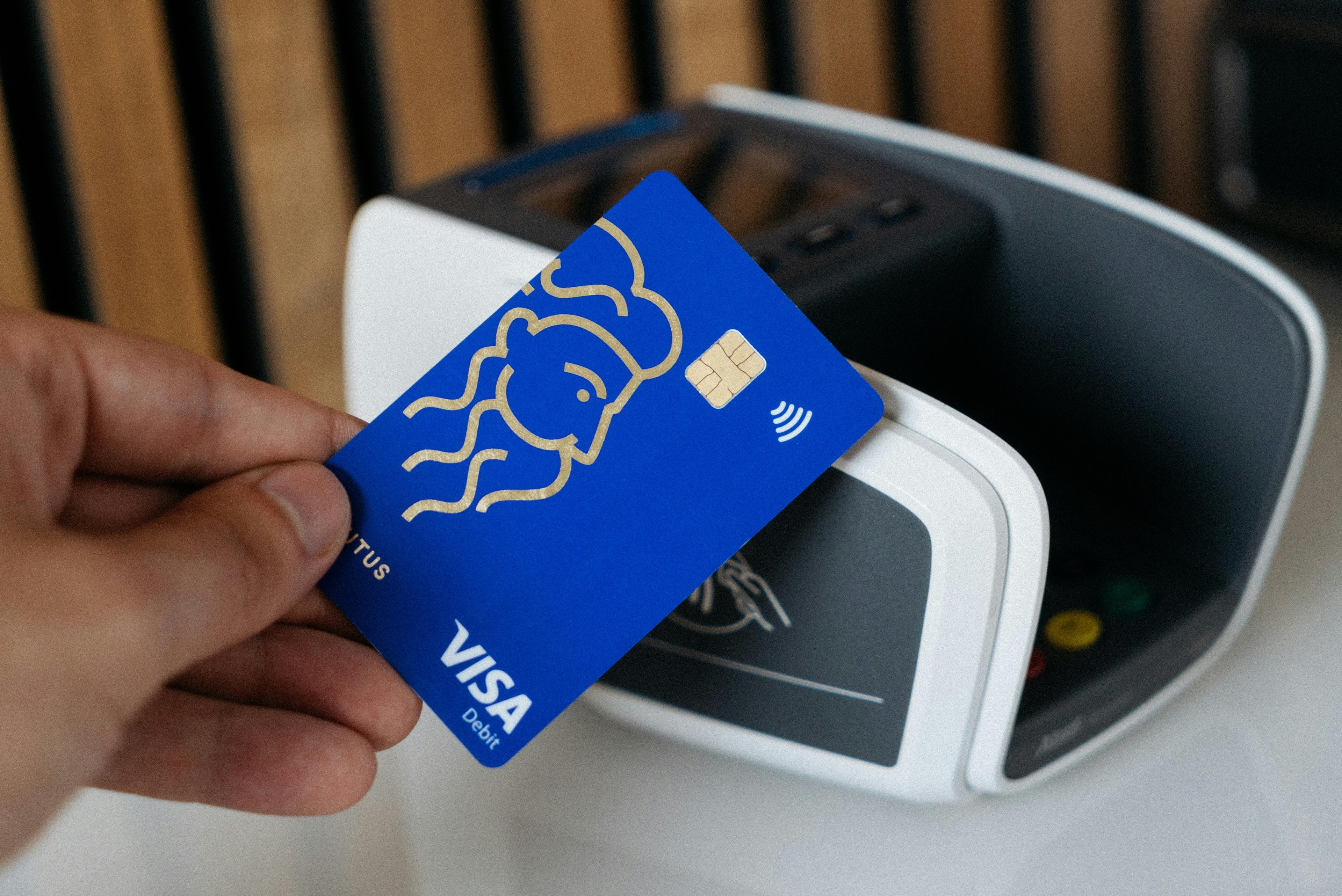 A Visa card being used at a payment terminal.