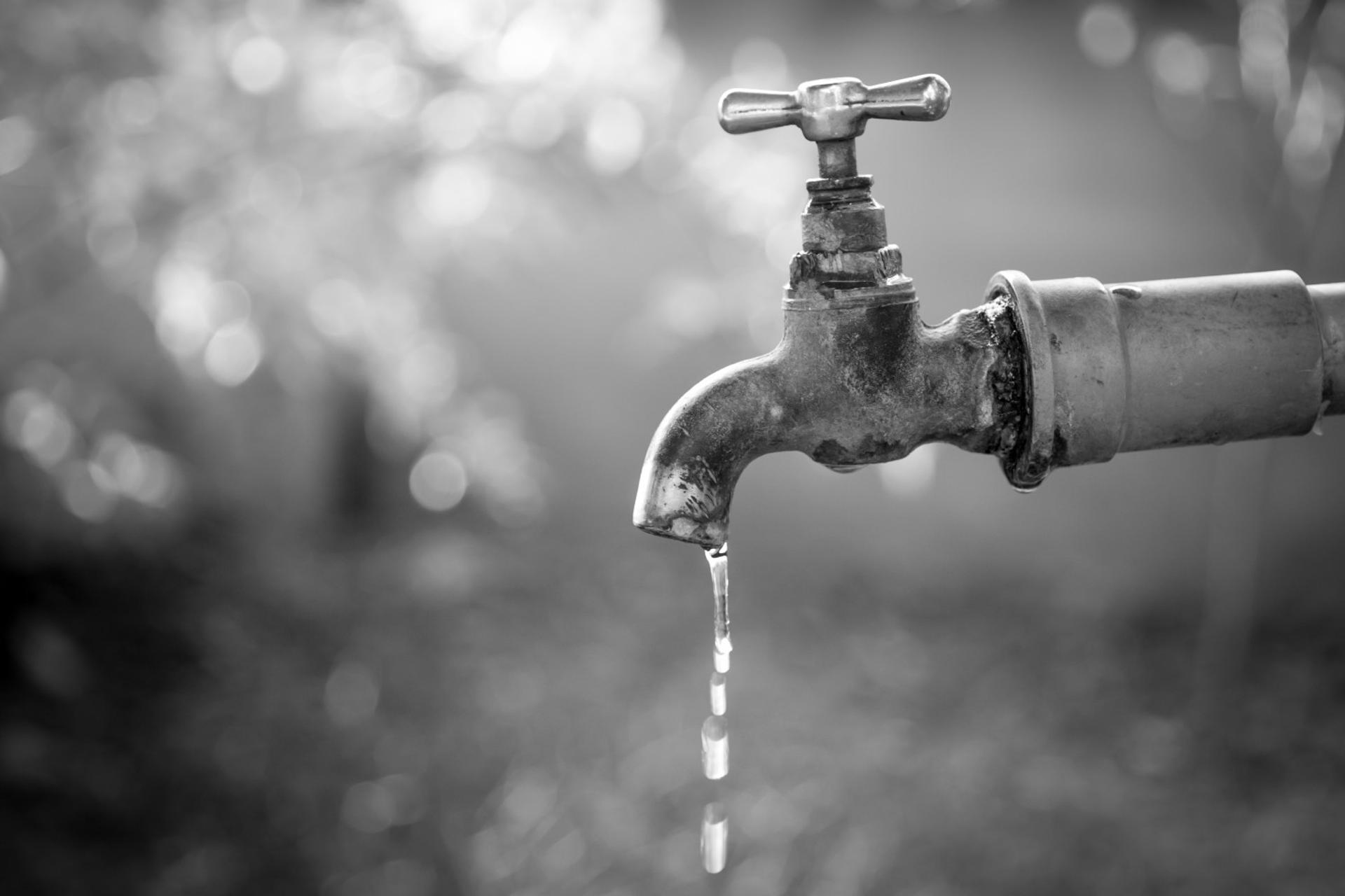 A dripping tap faucet, symbolizing the Bitcoin Faucet concept.