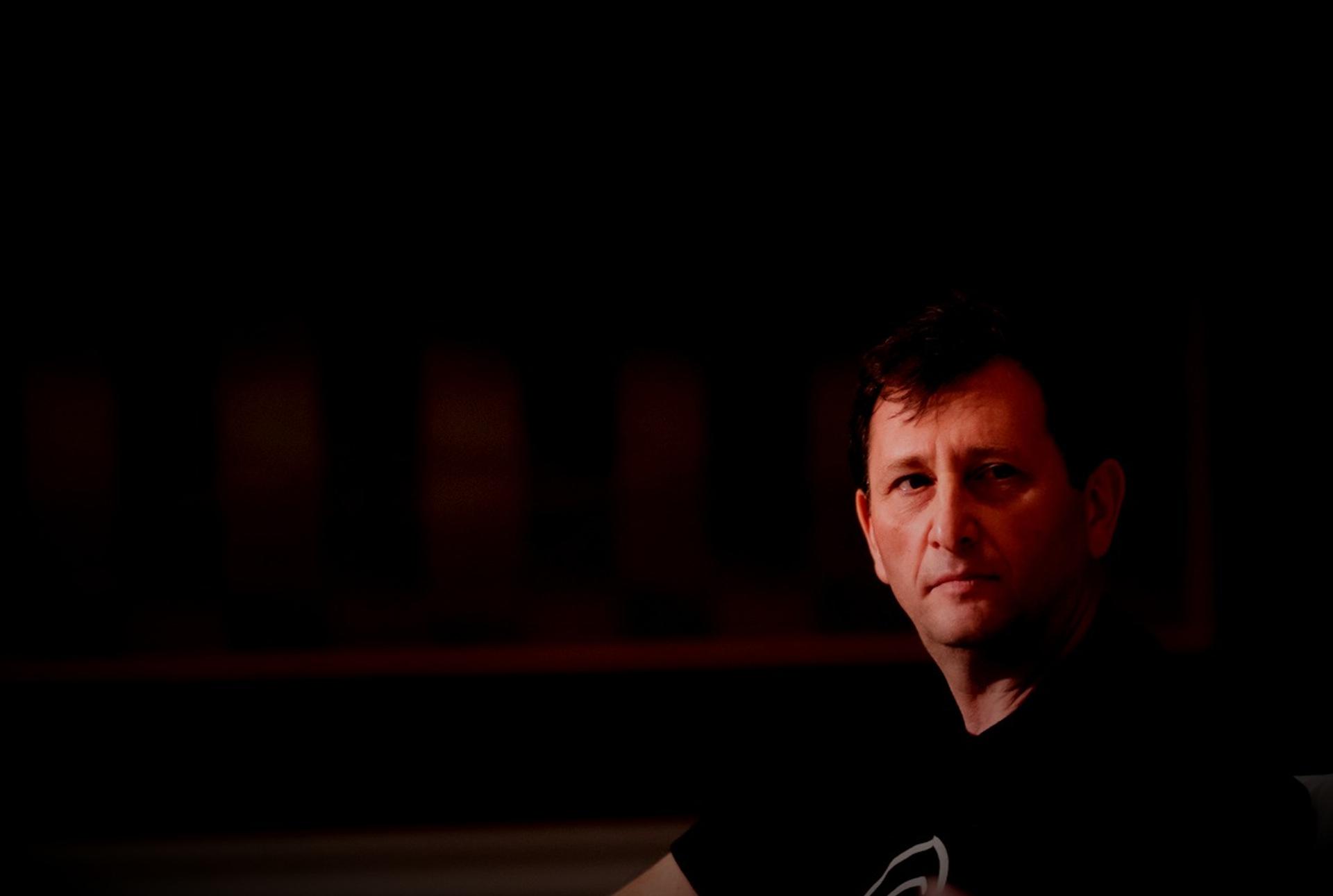 Former Celsius CEO Alex Mashinsky in shadow against a dark backgroud