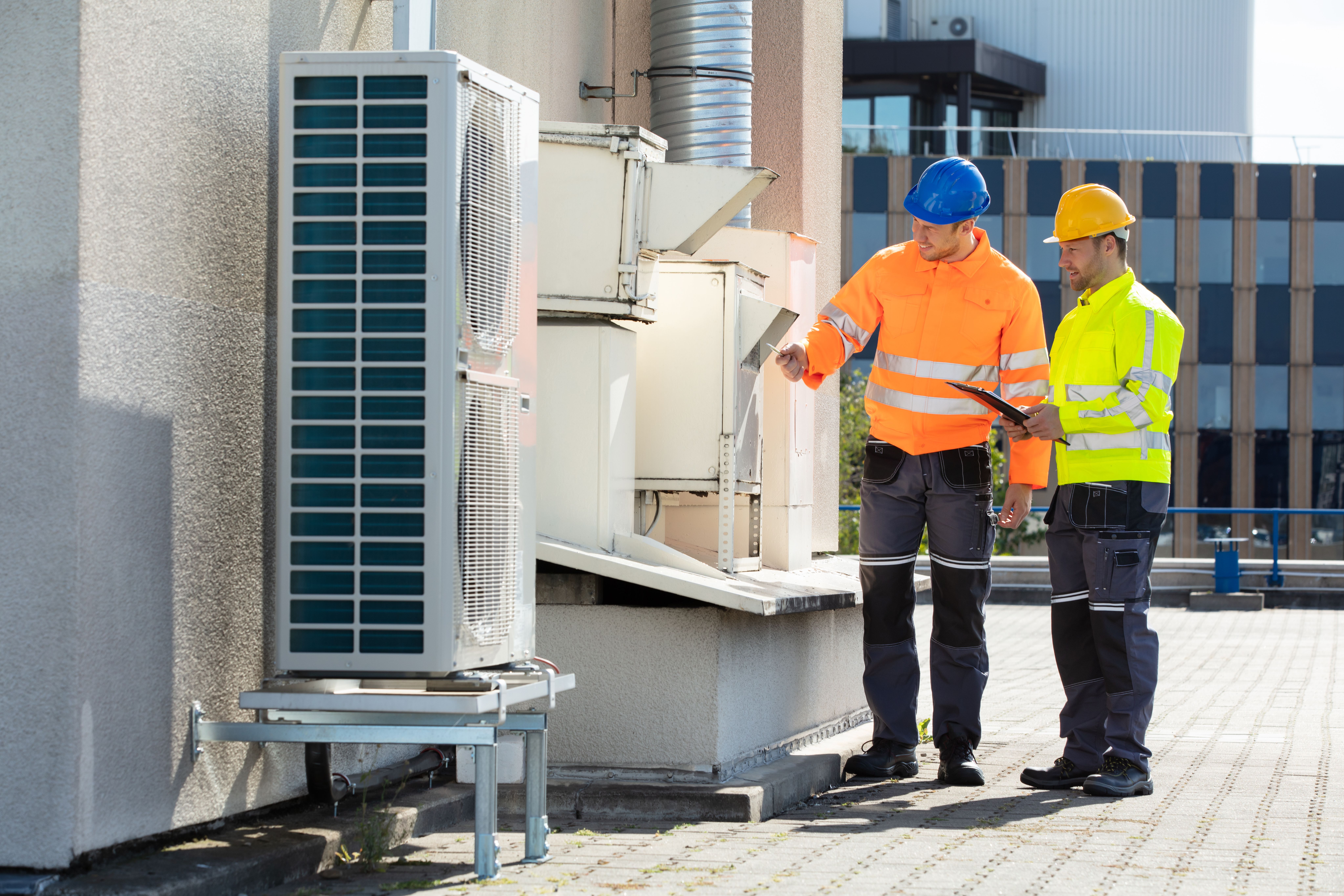Commercial HVAC technician servicing rooftop unit