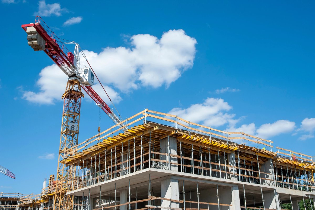Commercial construction superintendent reviewing plans on a jobsite — Commercial Construction salary guide cover