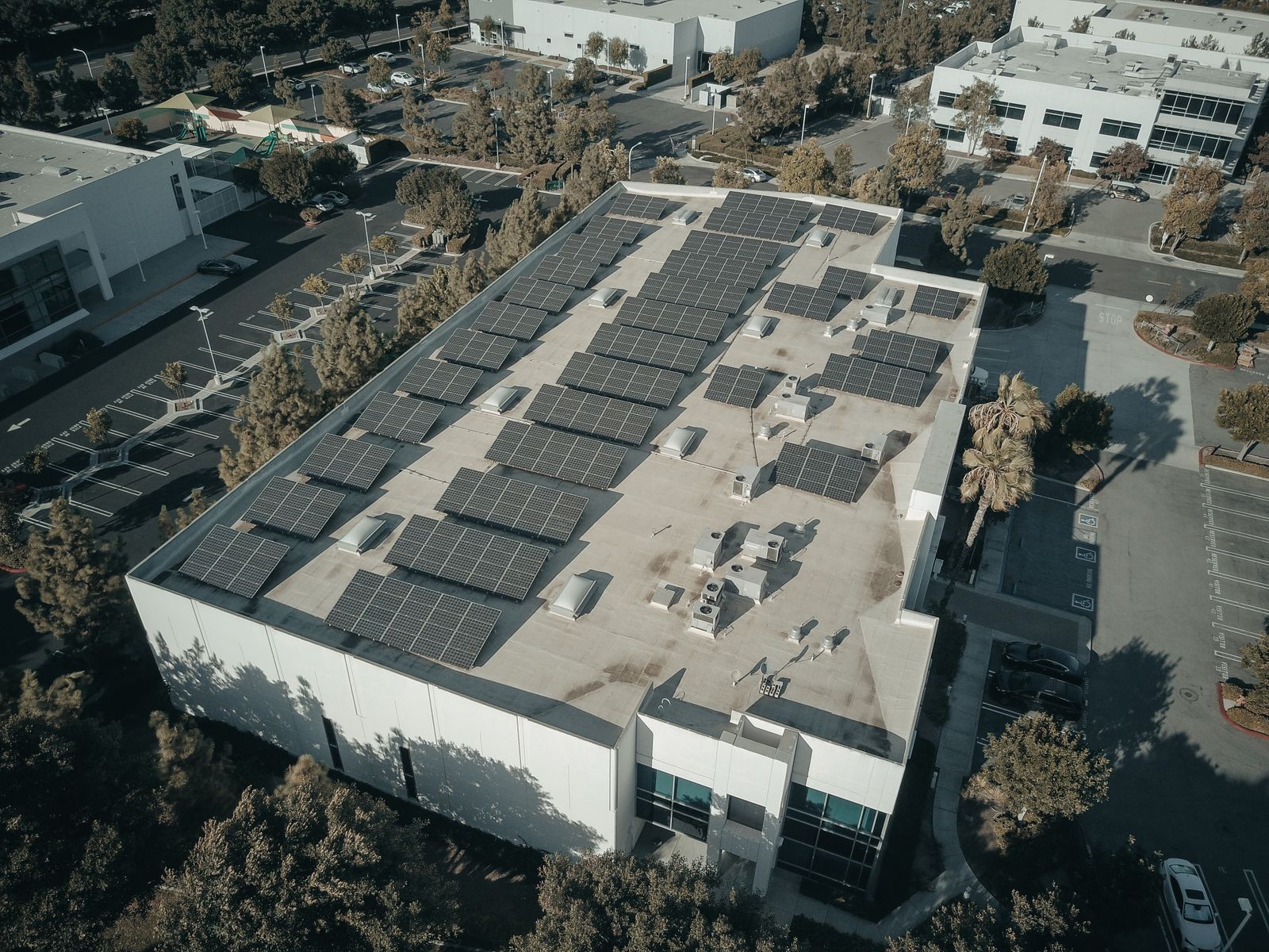 Aerial view of solar panels installed on a commercial building rooftop