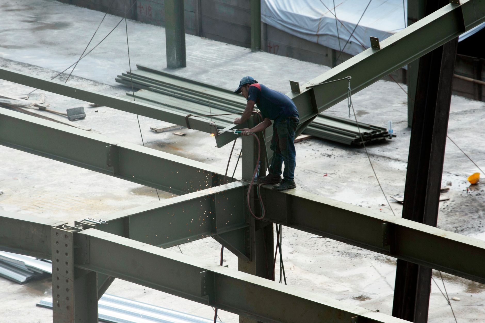 A construction worker on a steel-frame job site.