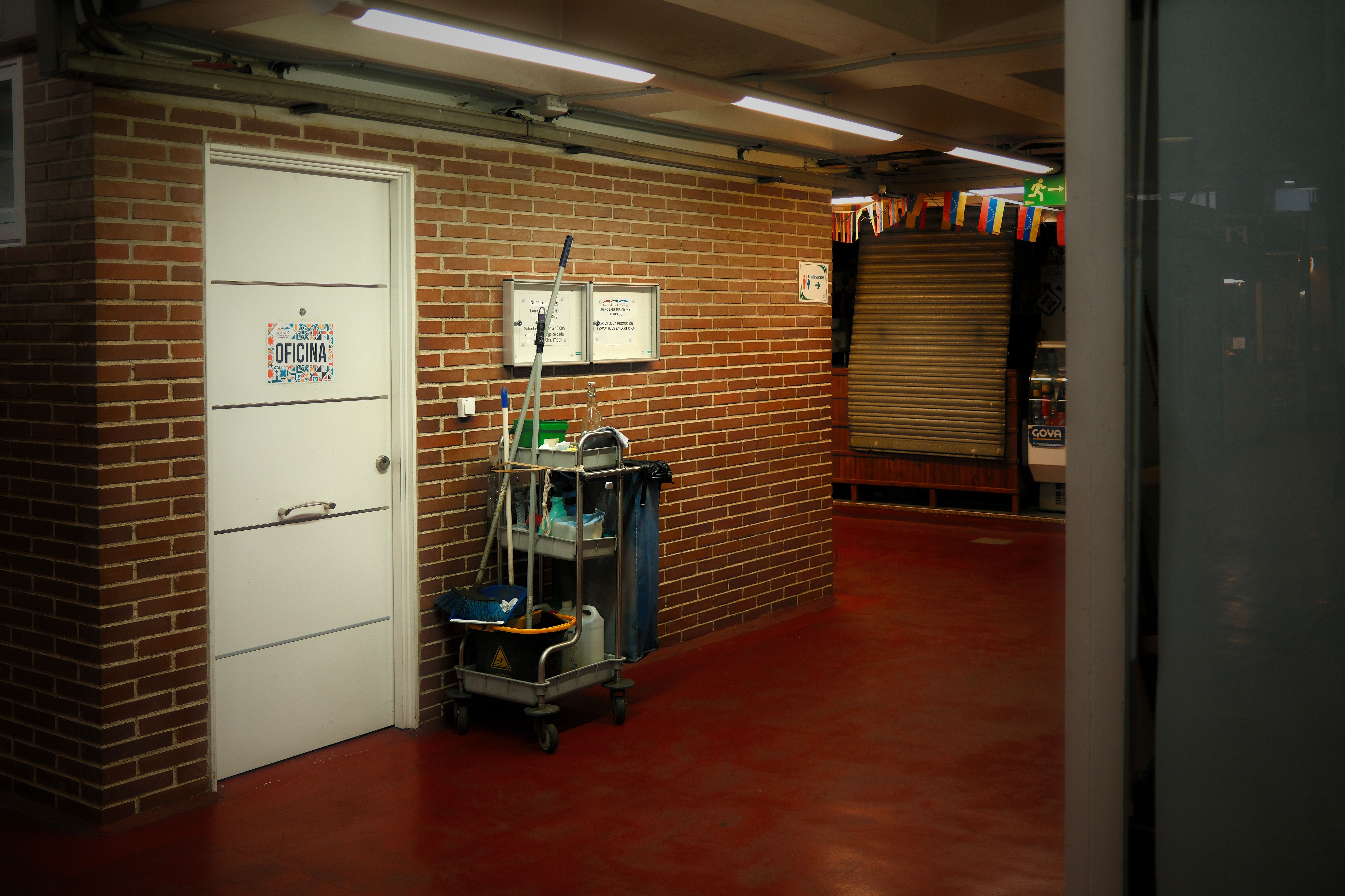 Commercial cleaning cart and supplies in an office building hallway
