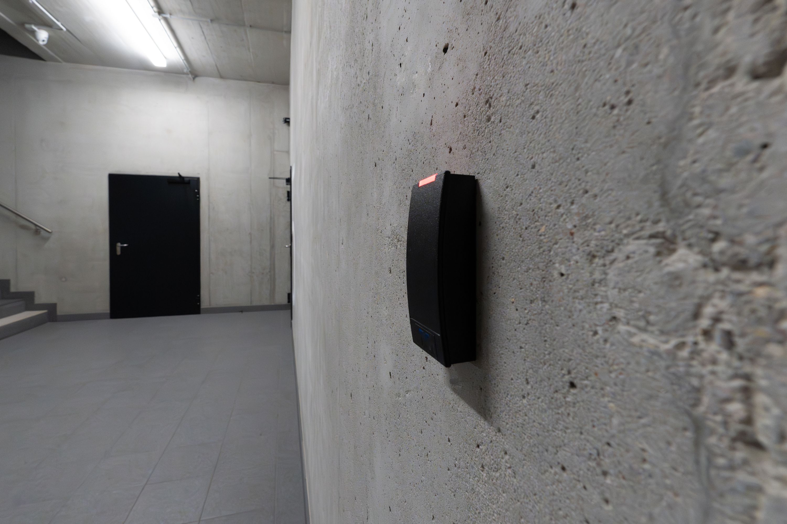 Electronic access-control terminal mounted on a commercial building wall.