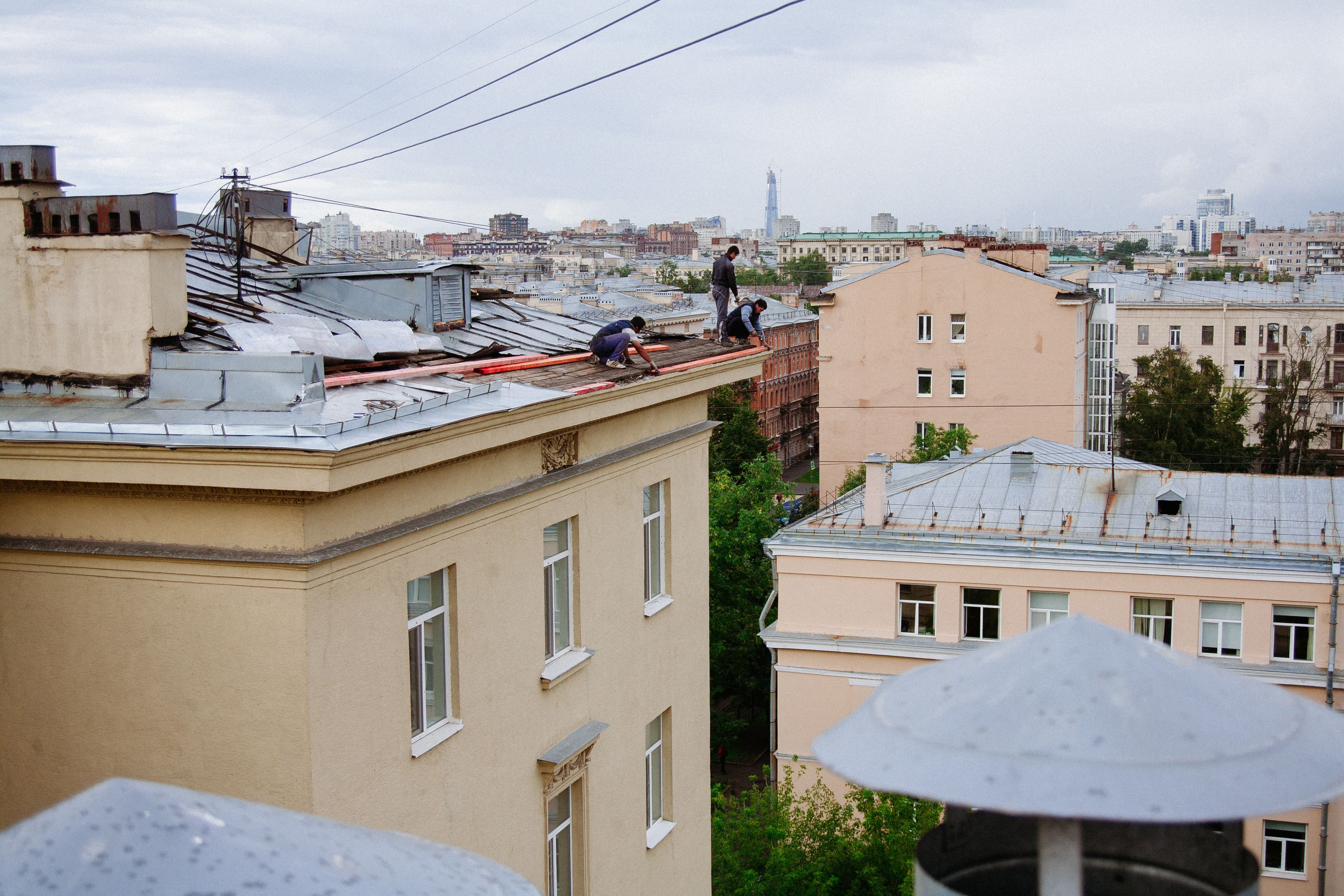Commercial roofing crew working on a rooftop, the kind of team a well-vetted foreman leads.