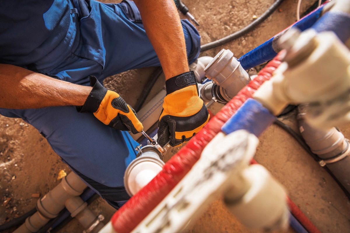 Commercial plumber installing large-scale piping — Commercial Plumbing salary guide cover