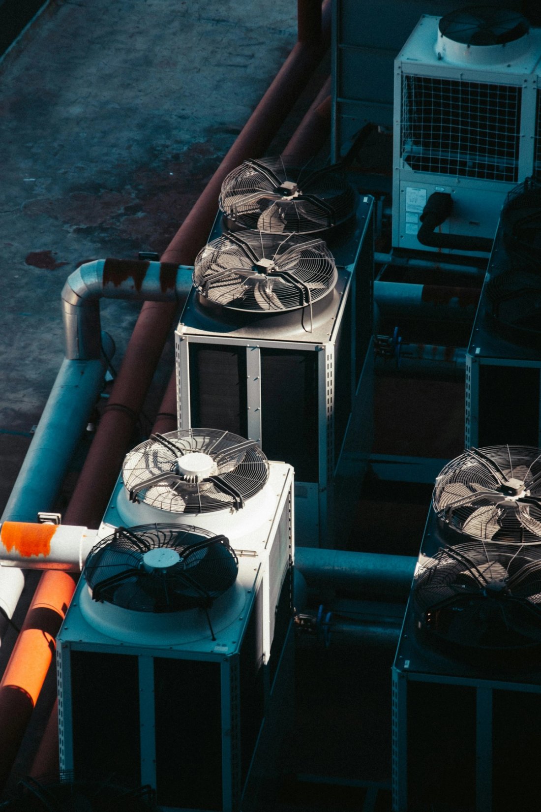 Commercial HVAC compressor units arrayed on a service deck
