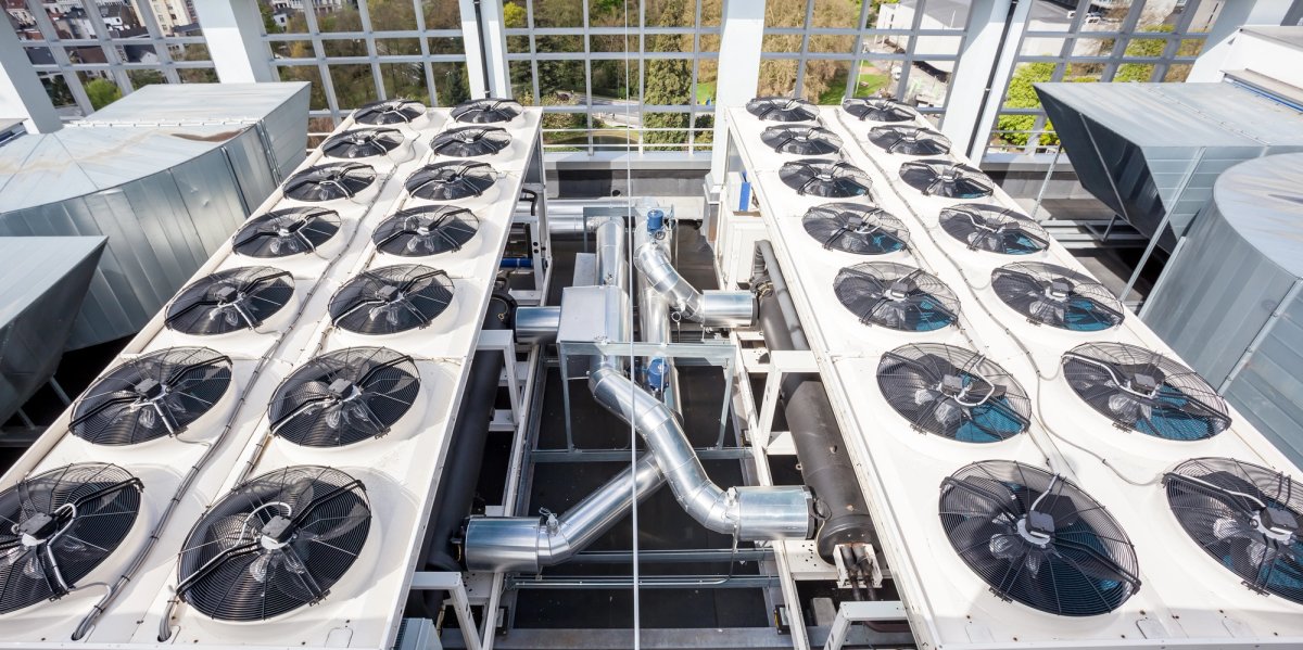 Commercial HVAC technician working on a rooftop unit — HVAC & Mechanical salary guide cover