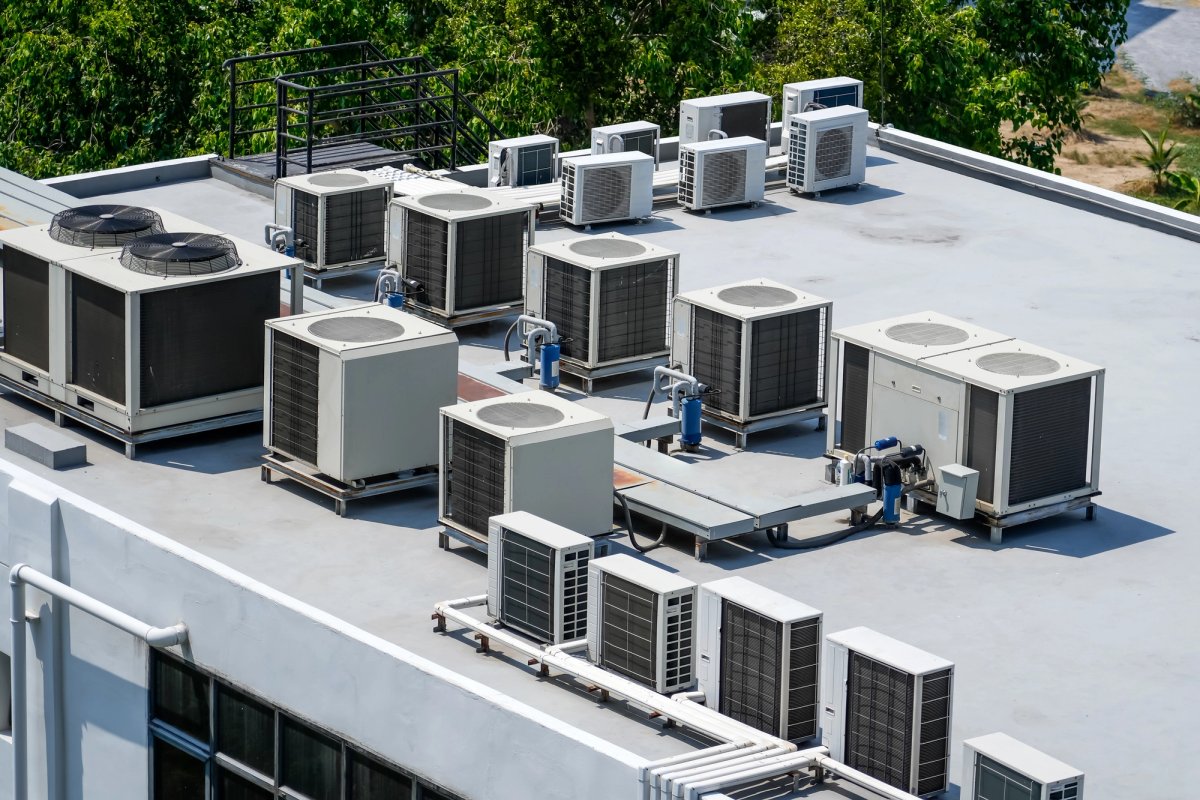 Commercial HVAC technician working on a rooftop unit — HVAC & Mechanical whitepaper cover
