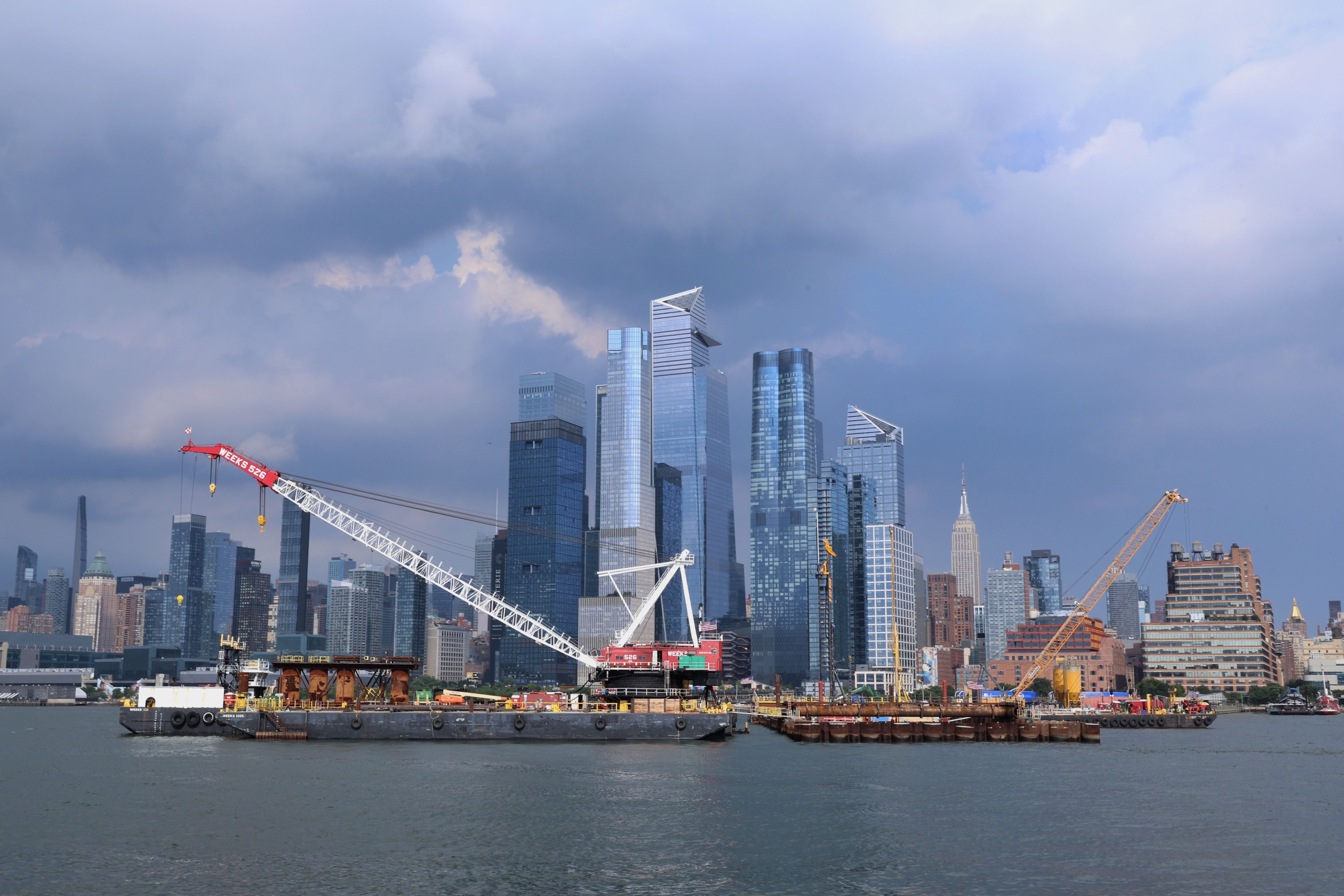 New York City skyline with construction cranes on the horizon.