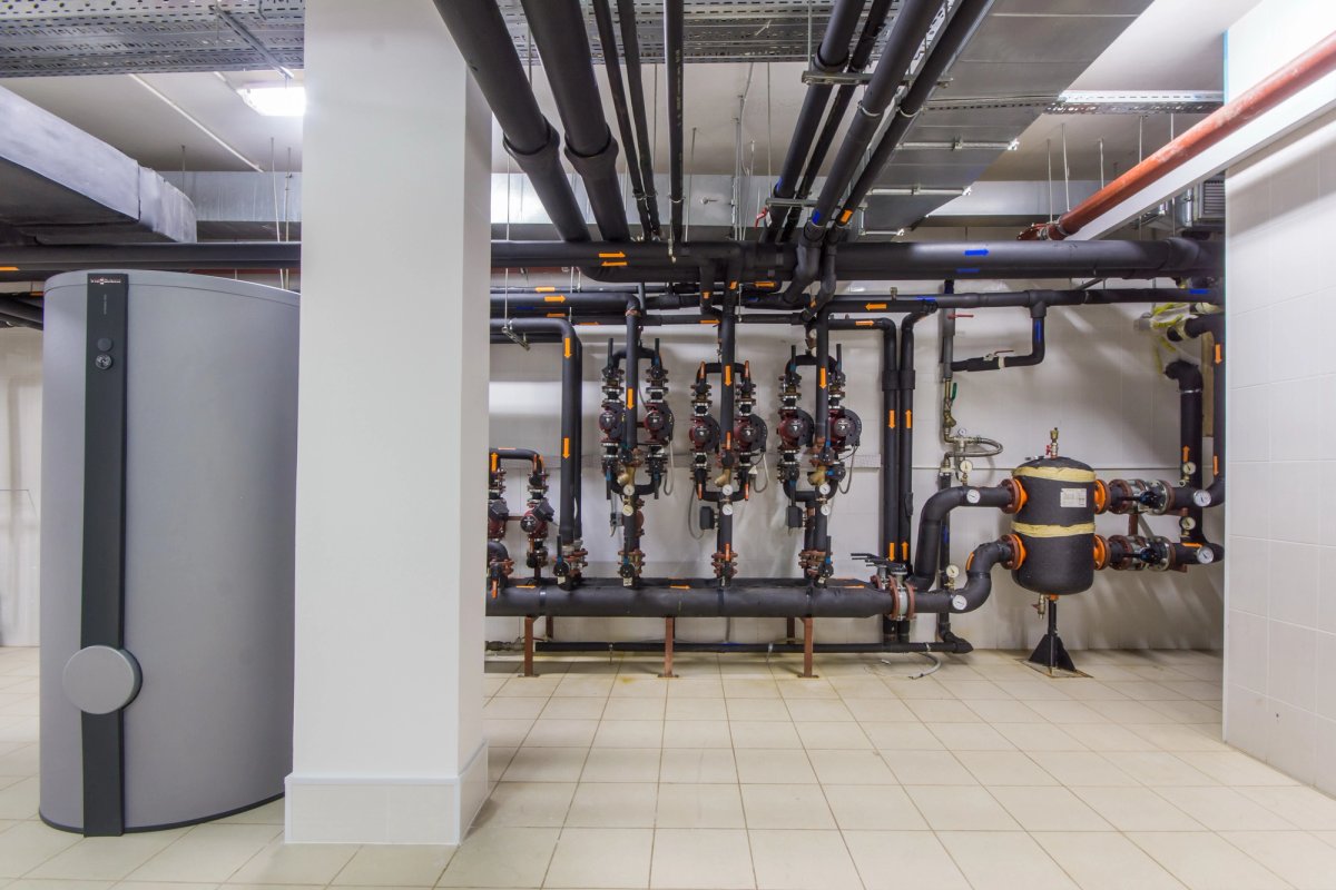 Commercial plumber installing large-scale piping — Commercial Plumbing salary guide cover