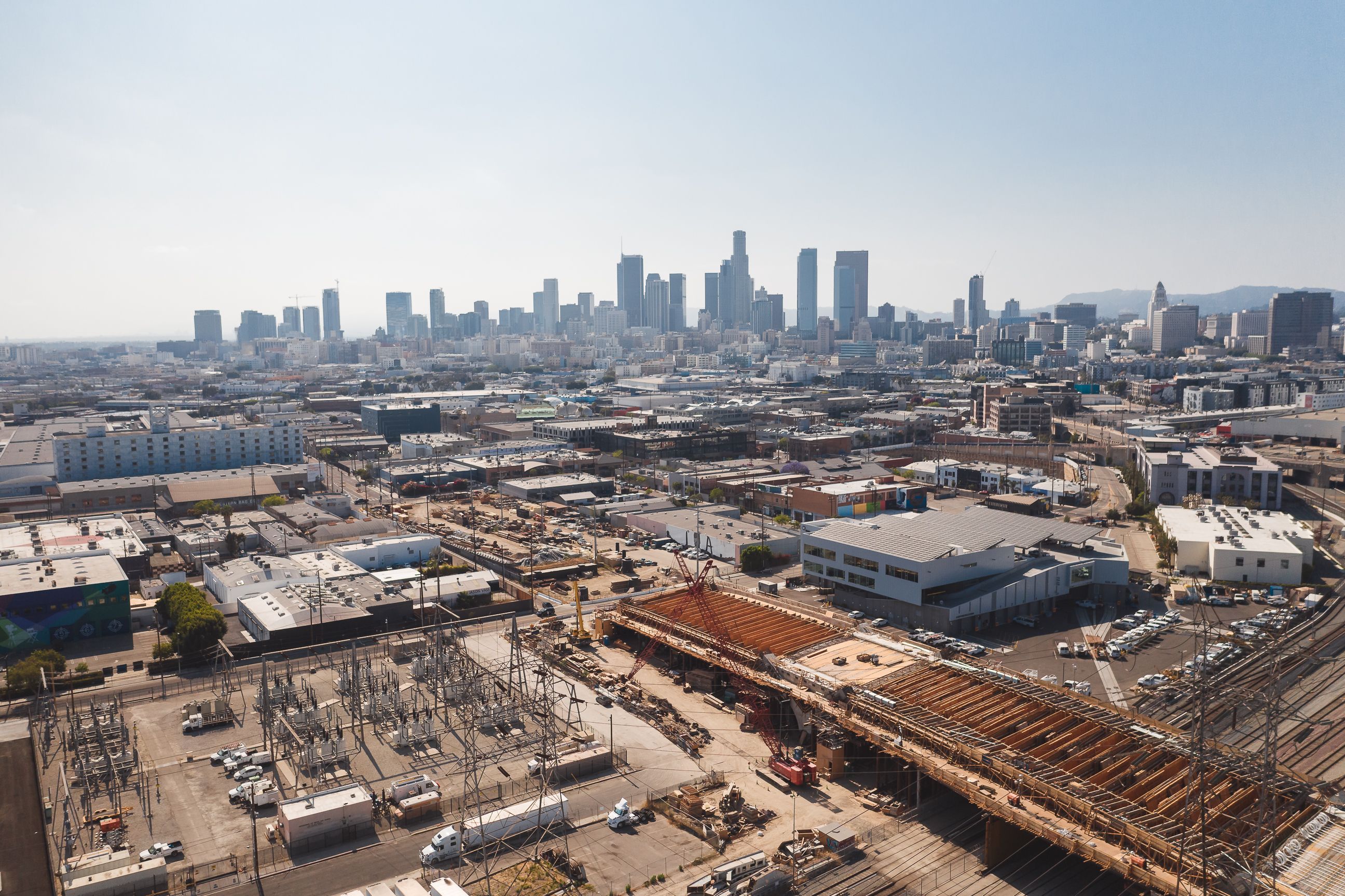 Aerial view of downtown Los Angeles with a construction site in the foreground.