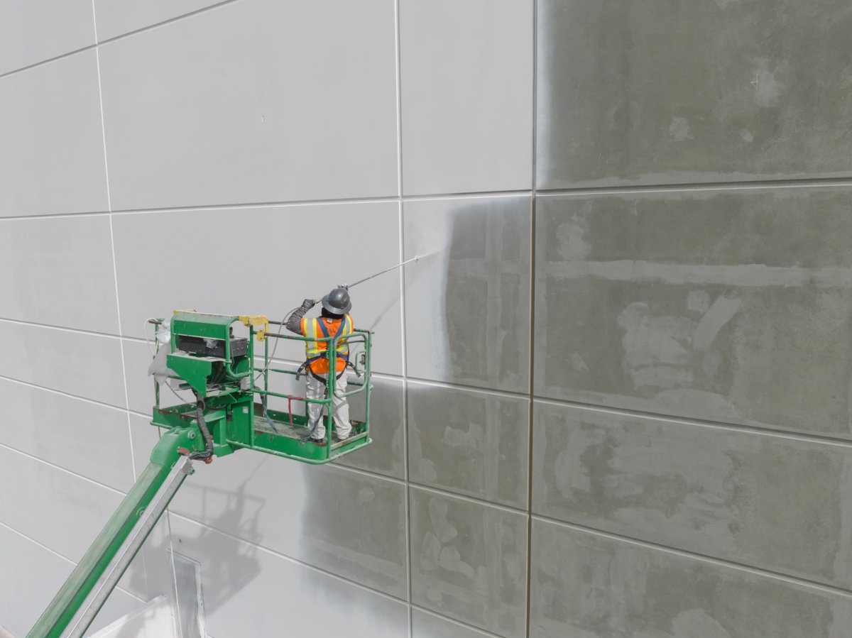 Commercial painter working on a large-scale interior coating project — Commercial Painting salary guide cover
