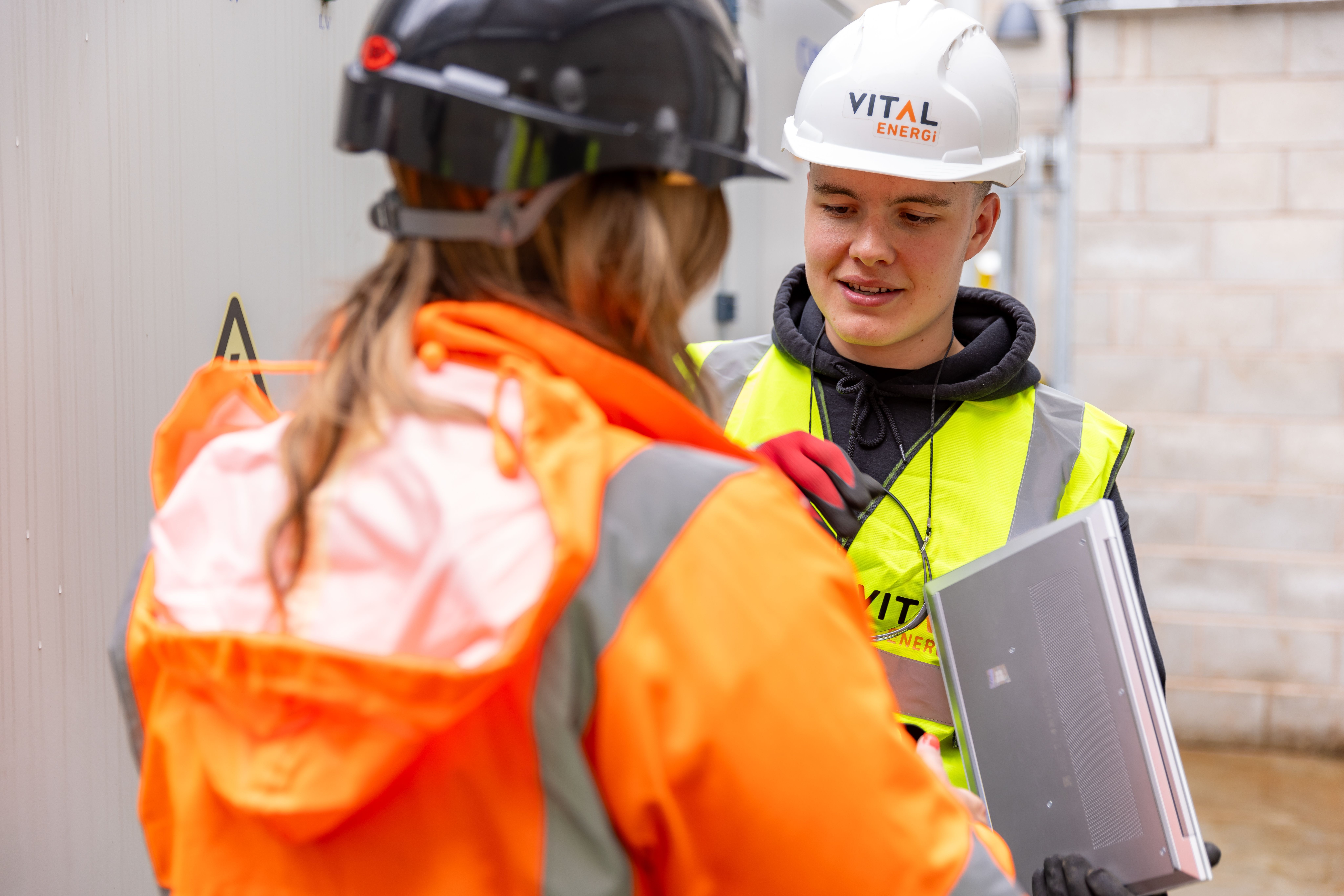 Two construction workers in safety gear collaborating on a jobsite, the kind of crew a well-vetted superintendent runs.