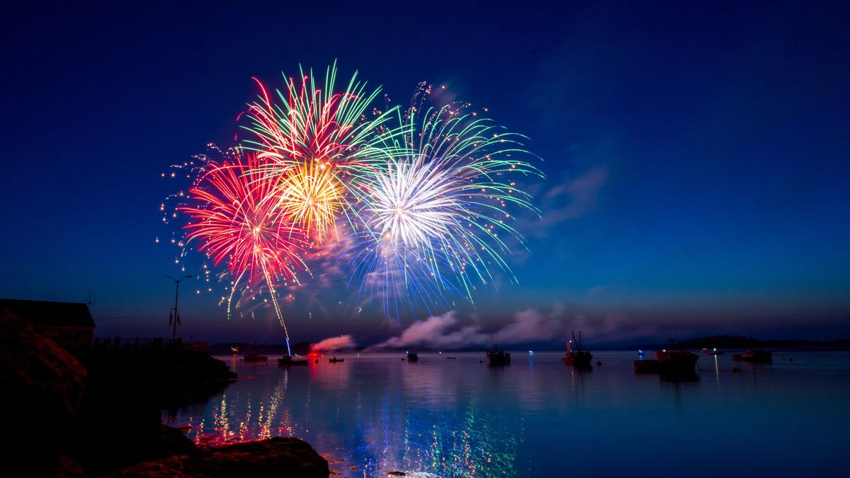 A fireworks display in the harbor of Lubec Maine. The dusk sky, water and boats provided a beautiful setting for the colorful show.