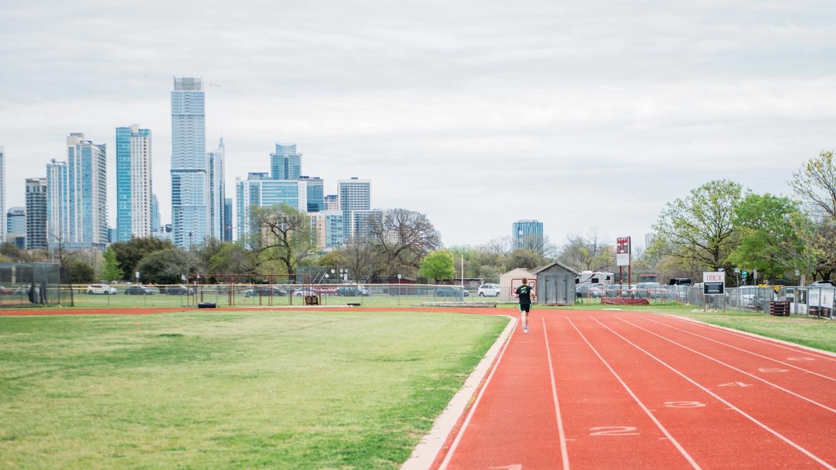 Running track with a city skyline in the background.