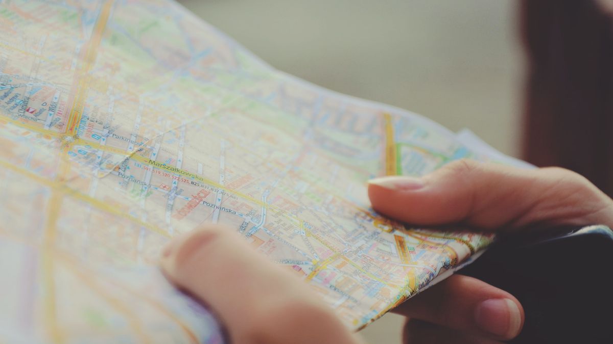 Hands holding a folded map.