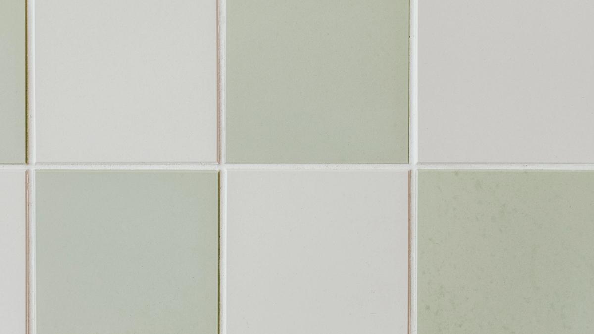 Plain sage green and white square tiles in a checkerboard pattern.