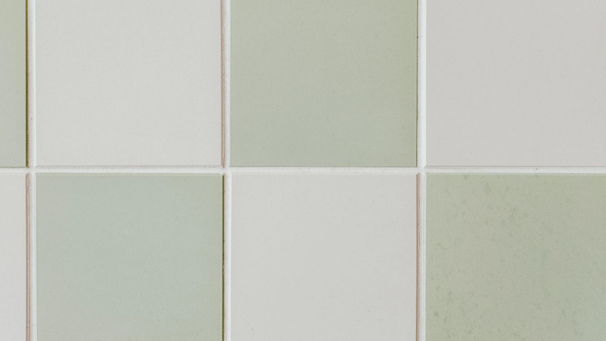 Plain sage green and white square tiles in a checkerboard pattern.