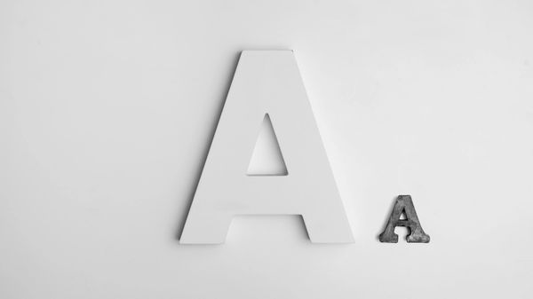 Big white letter A and small grey letter A on a white background.