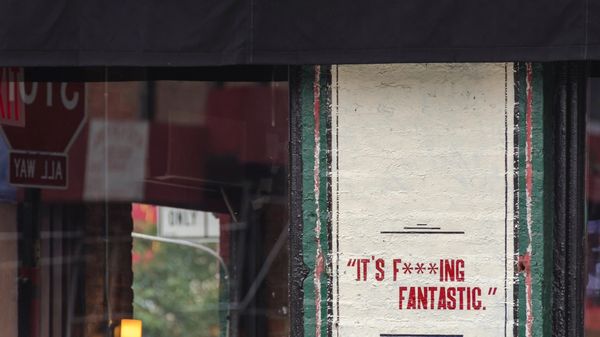 "It's f***ing fantastic." painted on a section of wall.