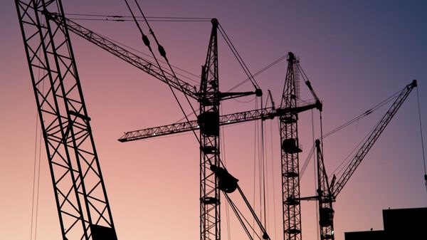 Silhouette of construction cranes.
