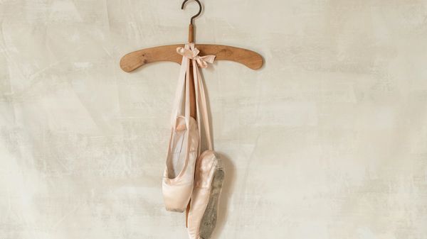 Ballet shoes on a hanger.