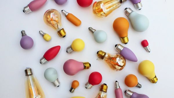 A selection of multi-coloured light bulbs against a white background.