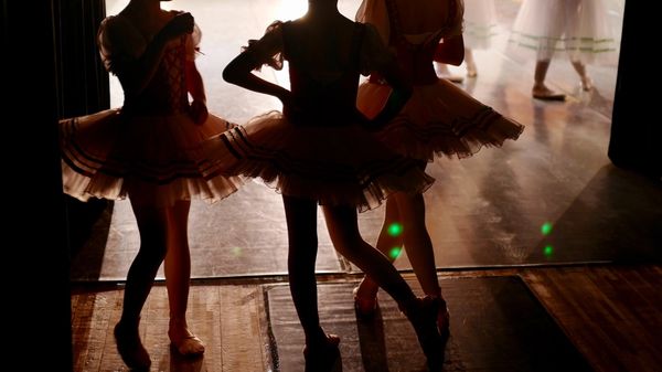 Child ballet dancers waiting in the wings to go on stage.