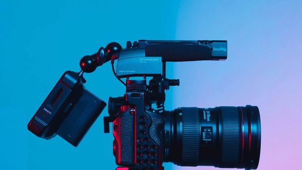 DSLR camera against a blue backdrop.