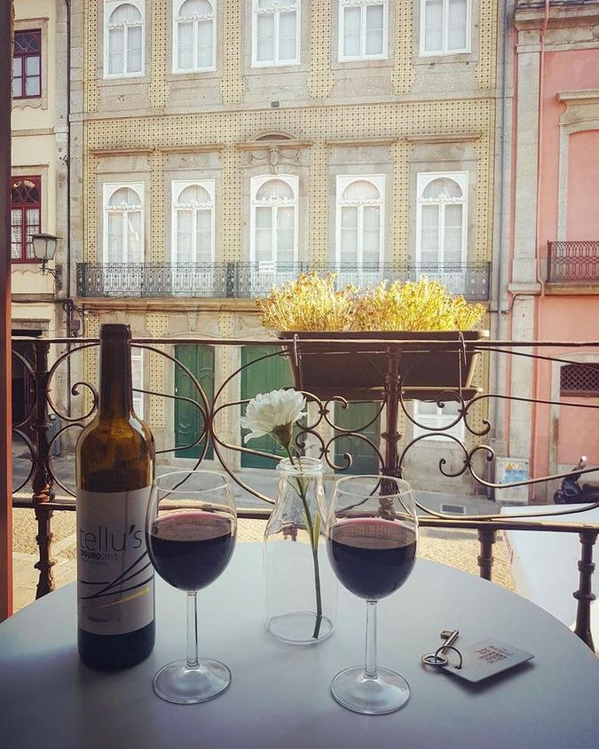 Wine on a table with a balcony view.