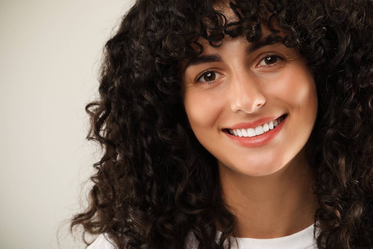 A woman smiling with a perfect set of teeth.