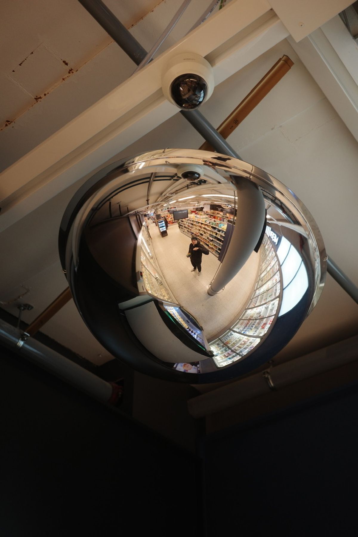 A self-portrait reflected in a convex security mirror
