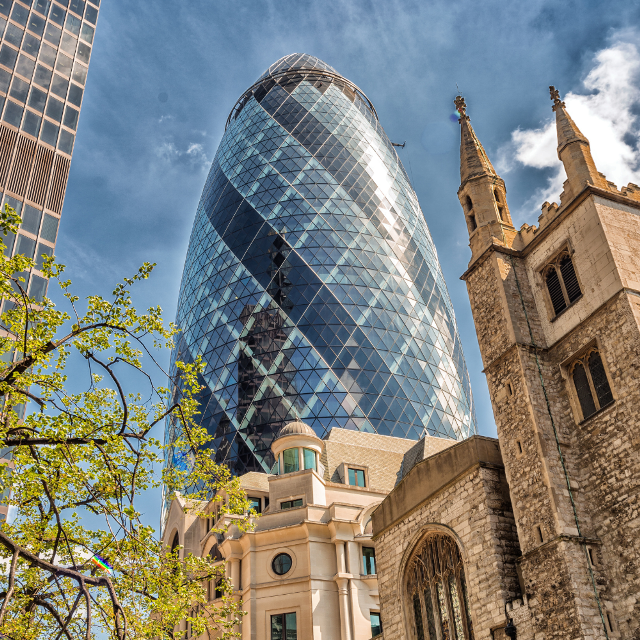 London's the gherkin building next to some old architecture