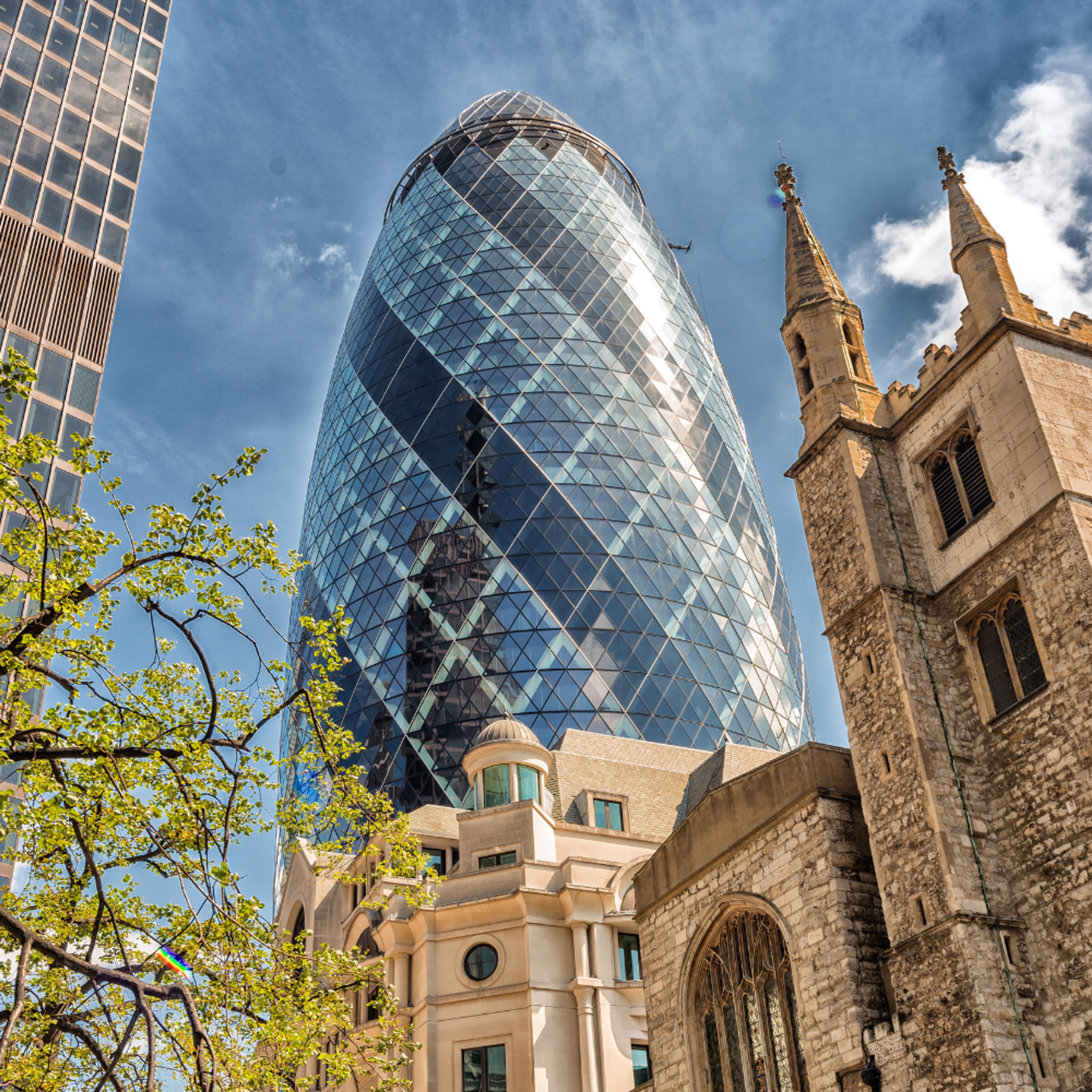 London's the gherkin building next to some old architecture