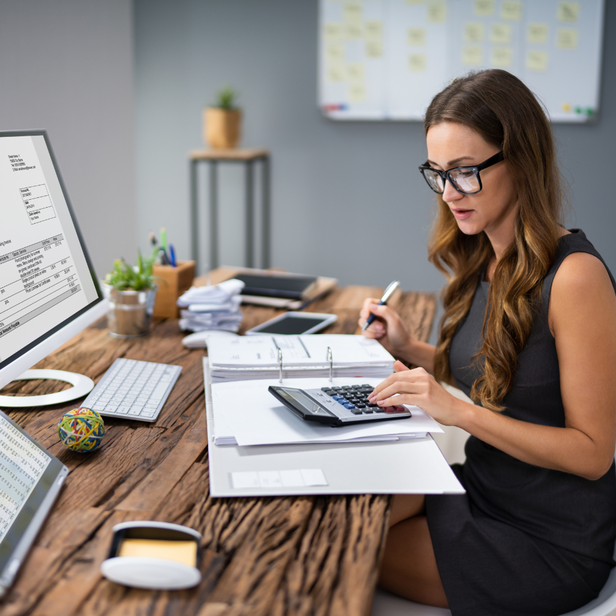 Finance woman at desk with calculator