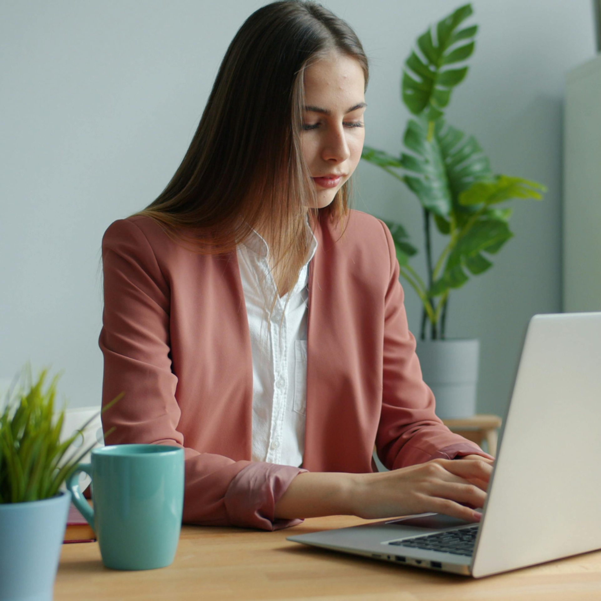 Lawyer working at desk in pink jacket