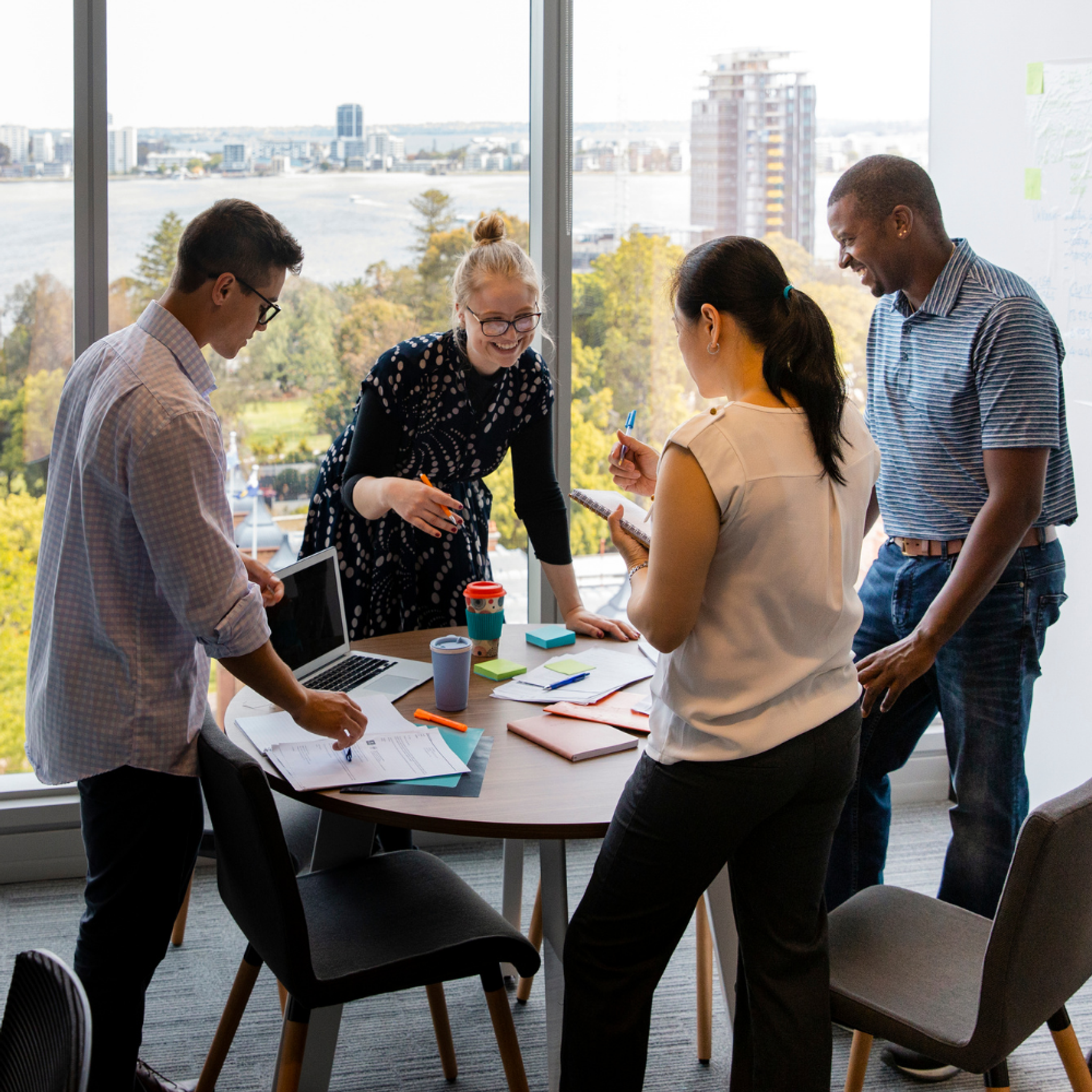 Team around table in front of glass window.png