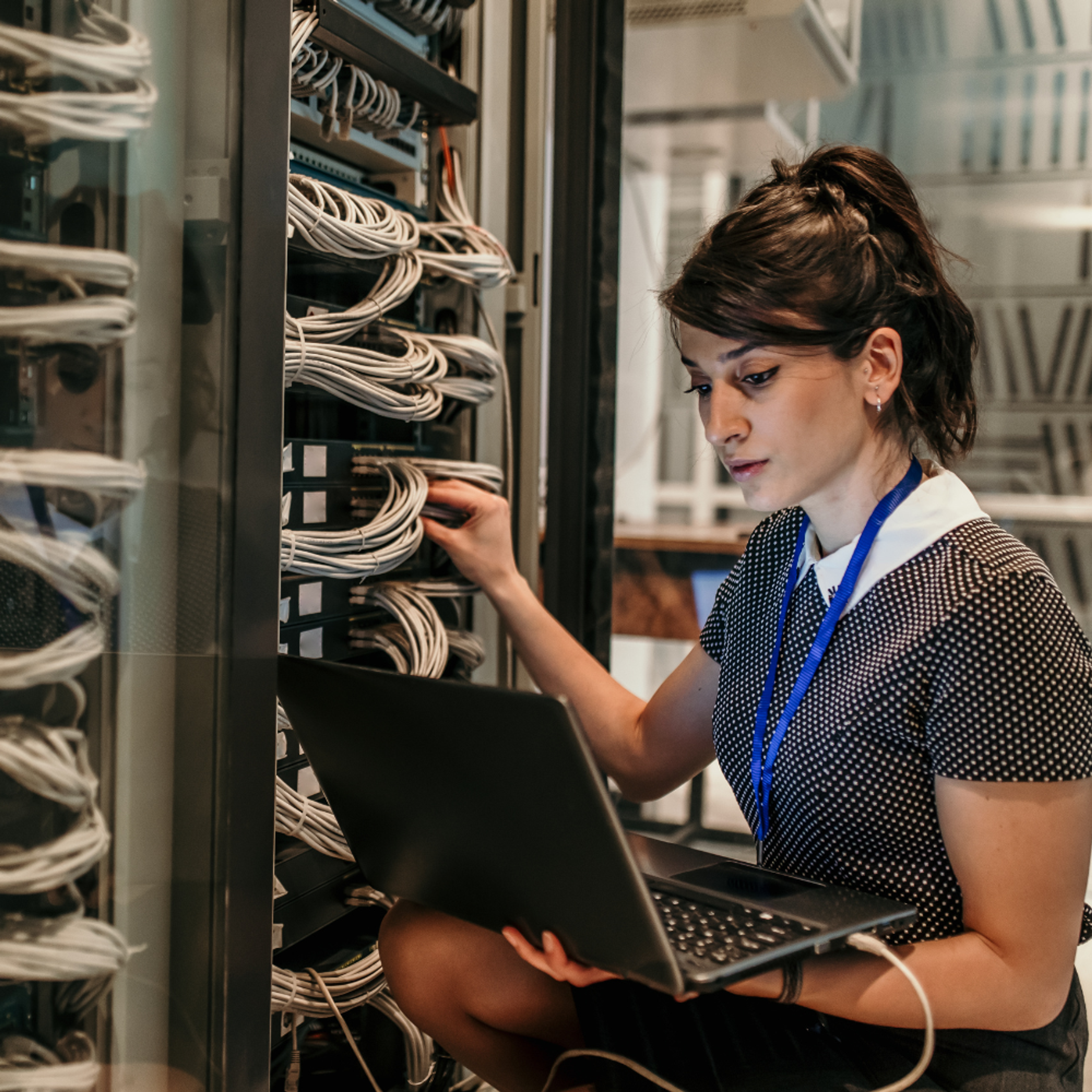 On premise servers IT person with laptop fixing