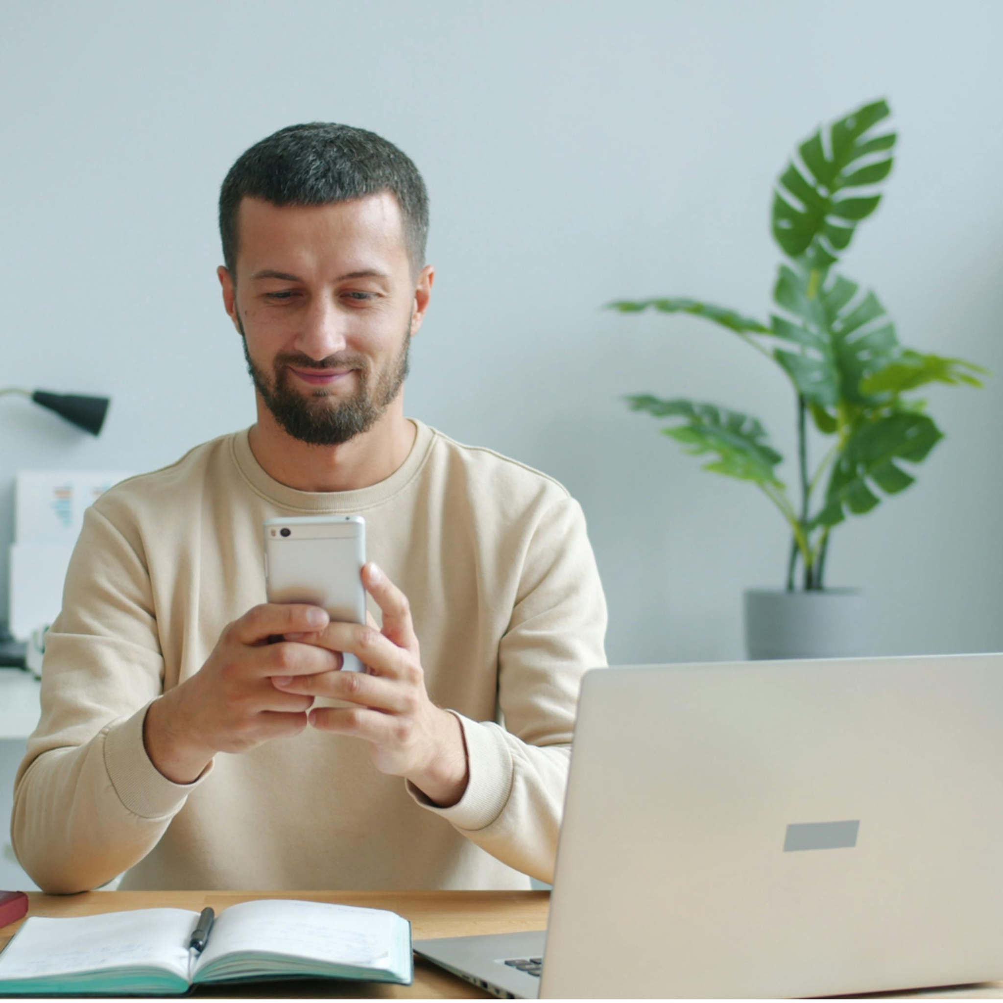 IT manager on his phone and laptop