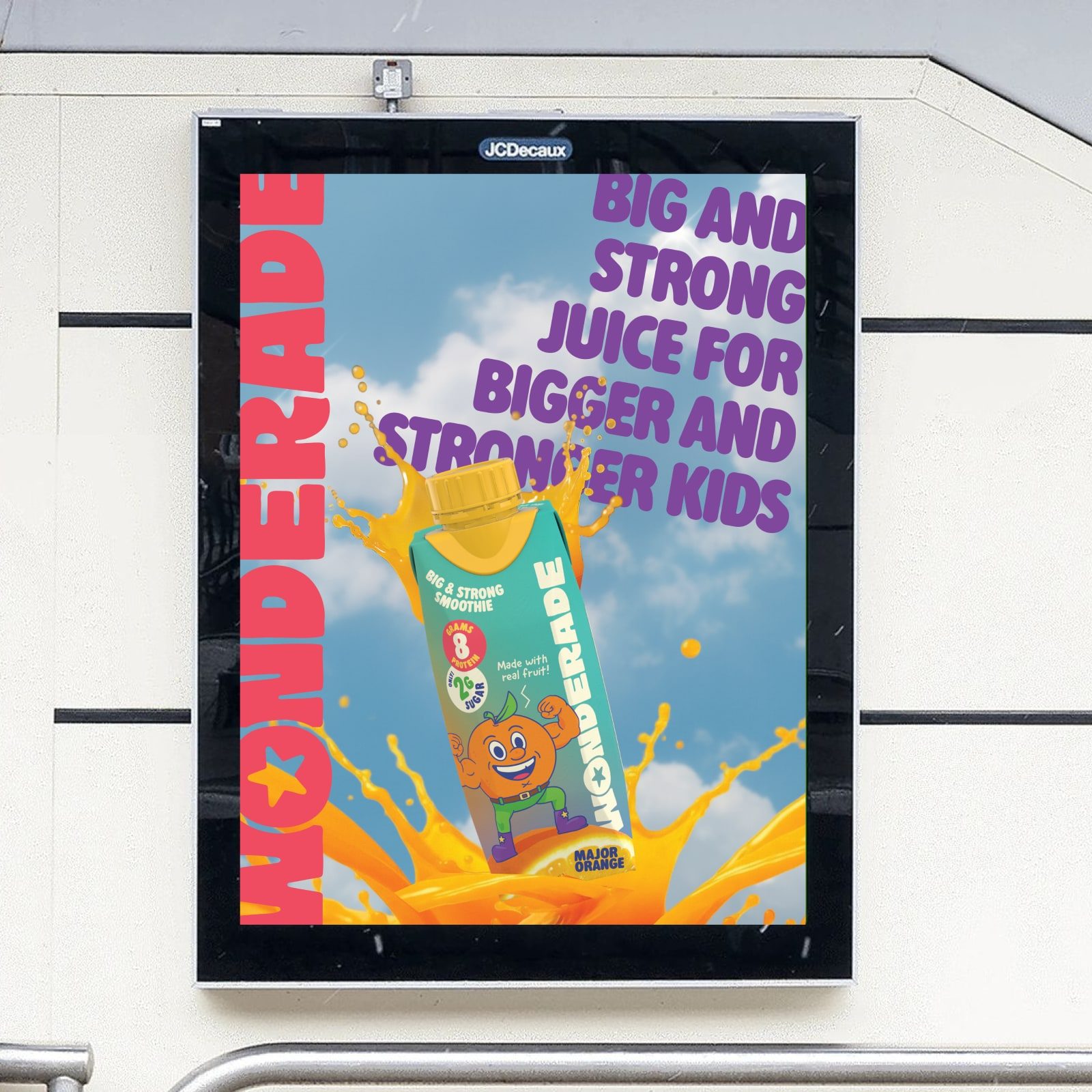 A bus-shelter poster reading “Big and strong juice for bigger and stronger kids,” with a Major Orange carton bursting out of a splash of juice.