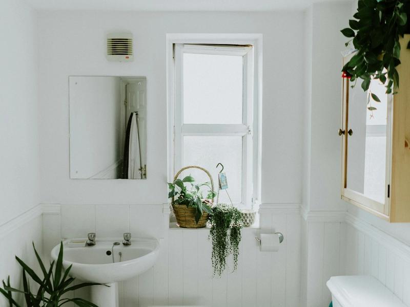 Modern remodeled bathroom with walk-in shower and natural light