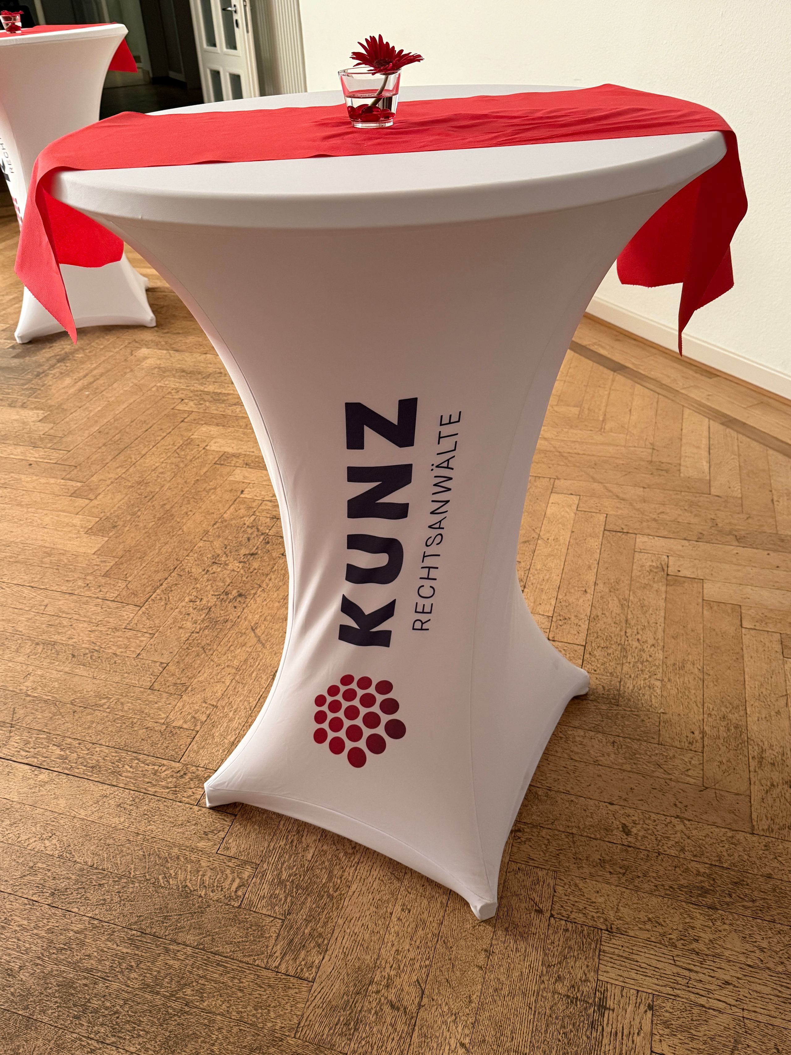 Stehtisch mit KUNZ-Husse und rotem Tischläufer