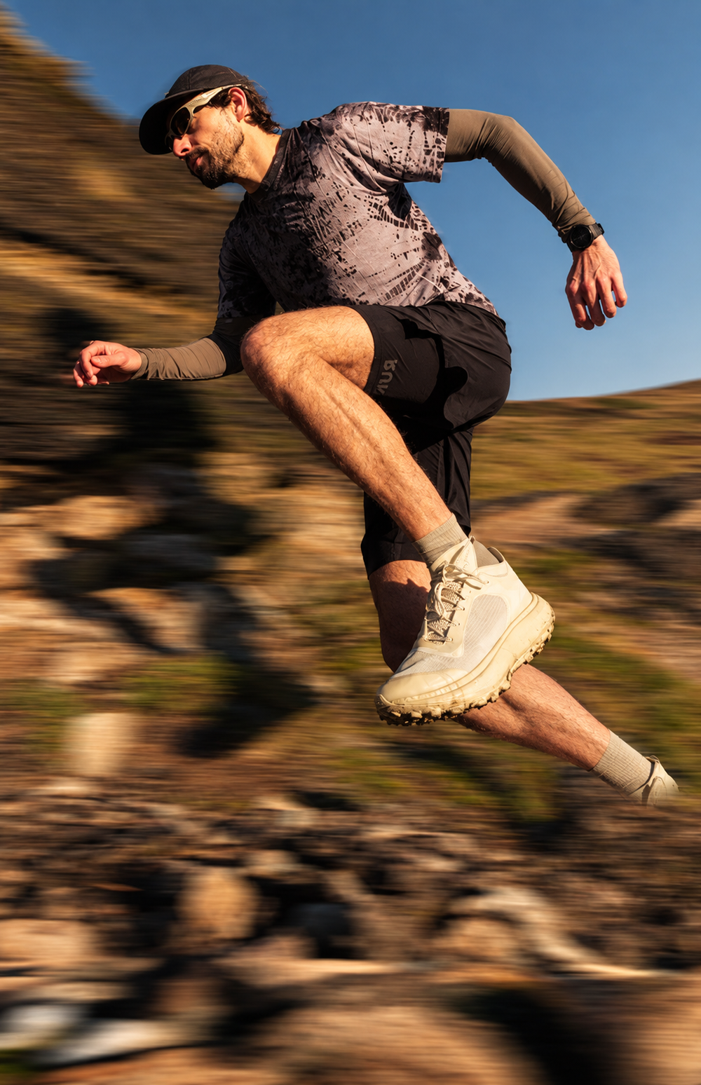 Trail runner mid-stride on a mountain path