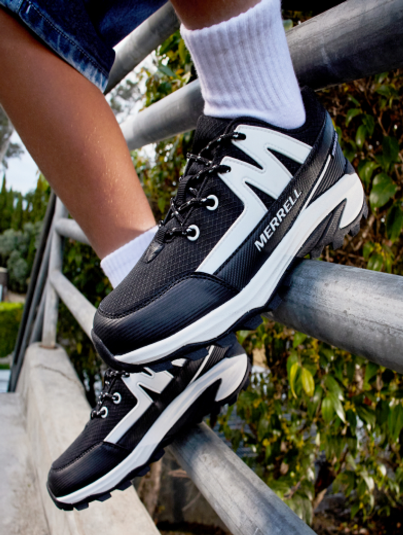 Close-up of Merrell sneakers on a metal railing