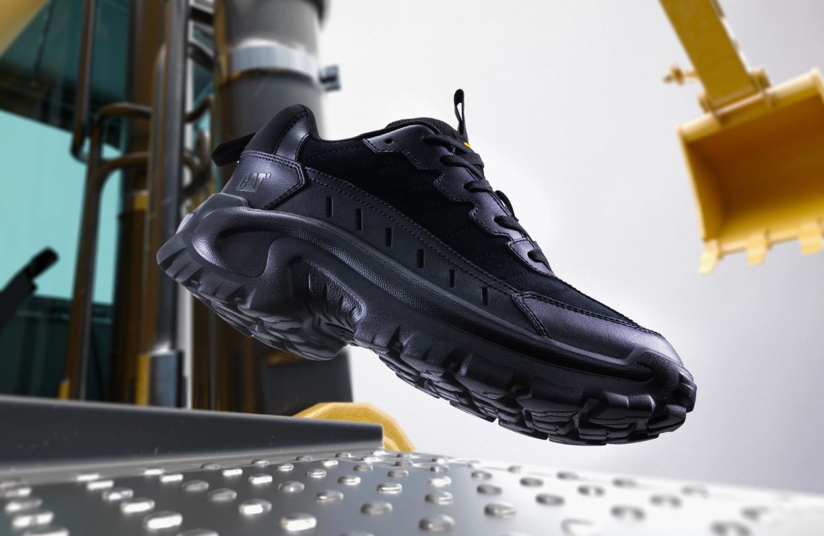 Black Cat Footwear sneaker on an industrial background