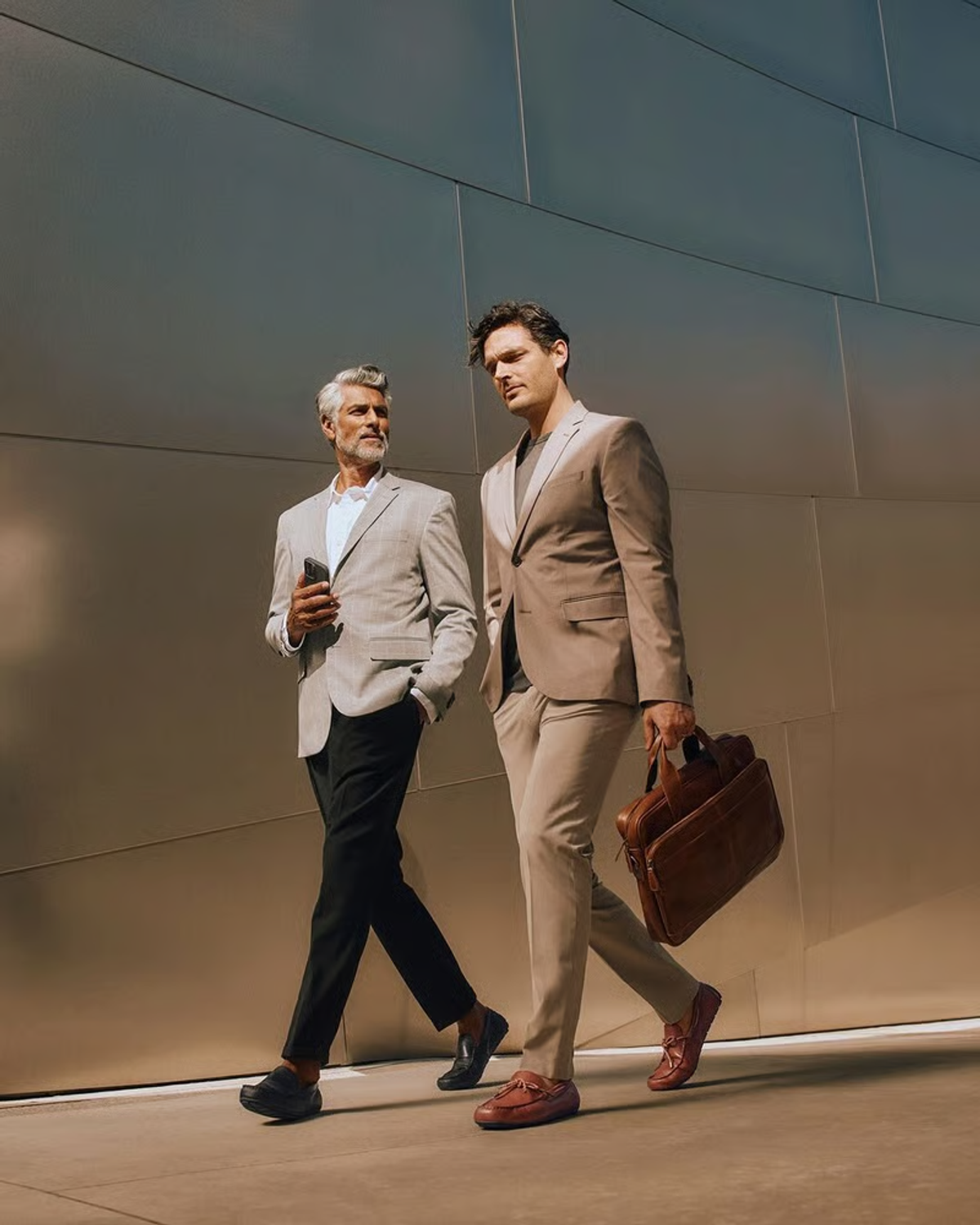 Two businessmen walking outside an office building