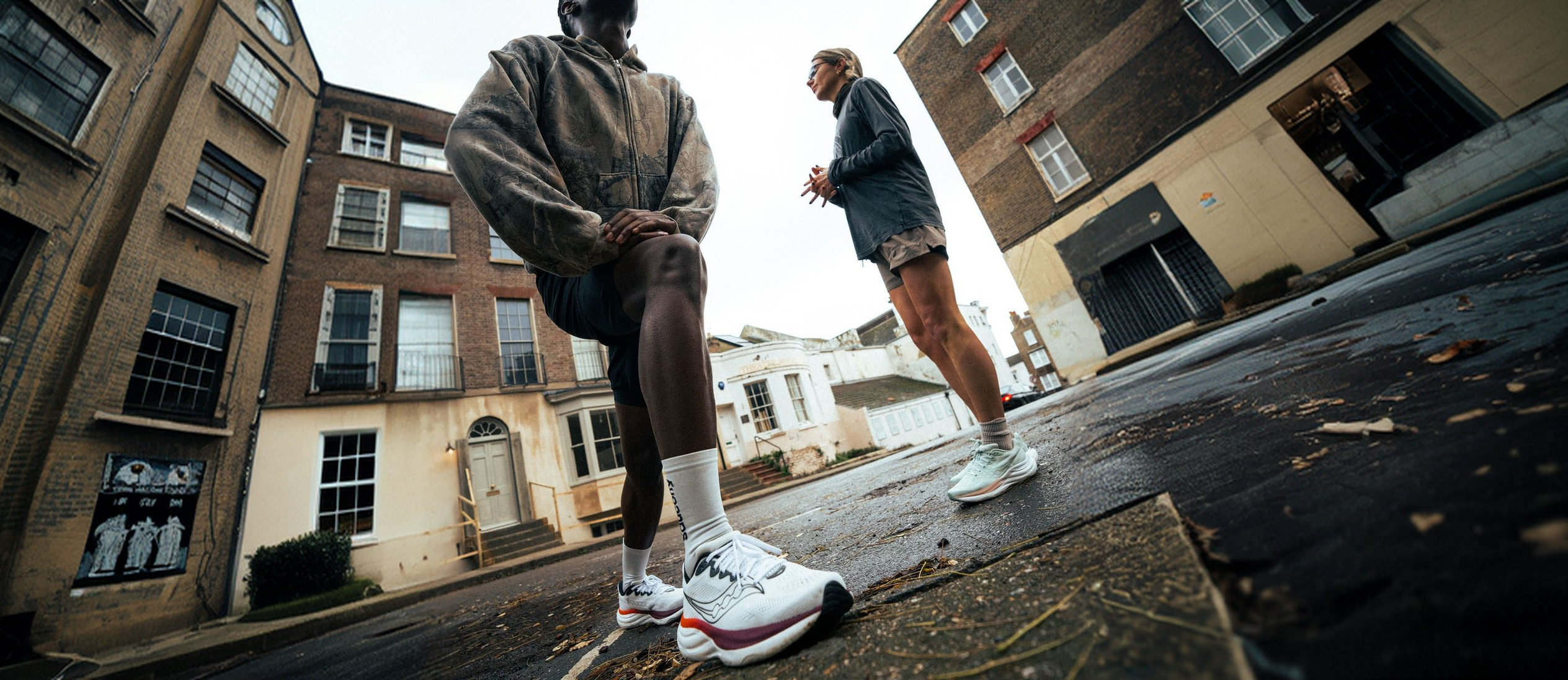 Two runners talking in a London street, shot from a low angle