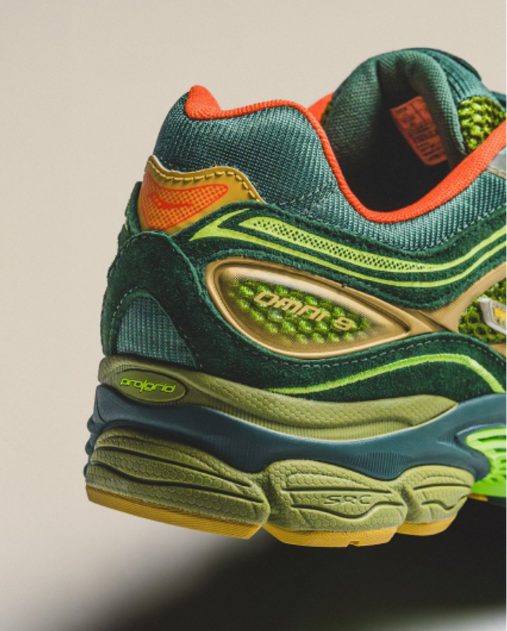 Close-up of a green and orange trail running shoe heel